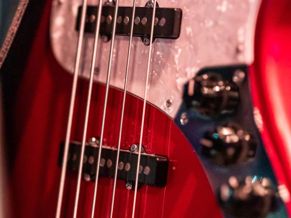 red bass guitar with five strings